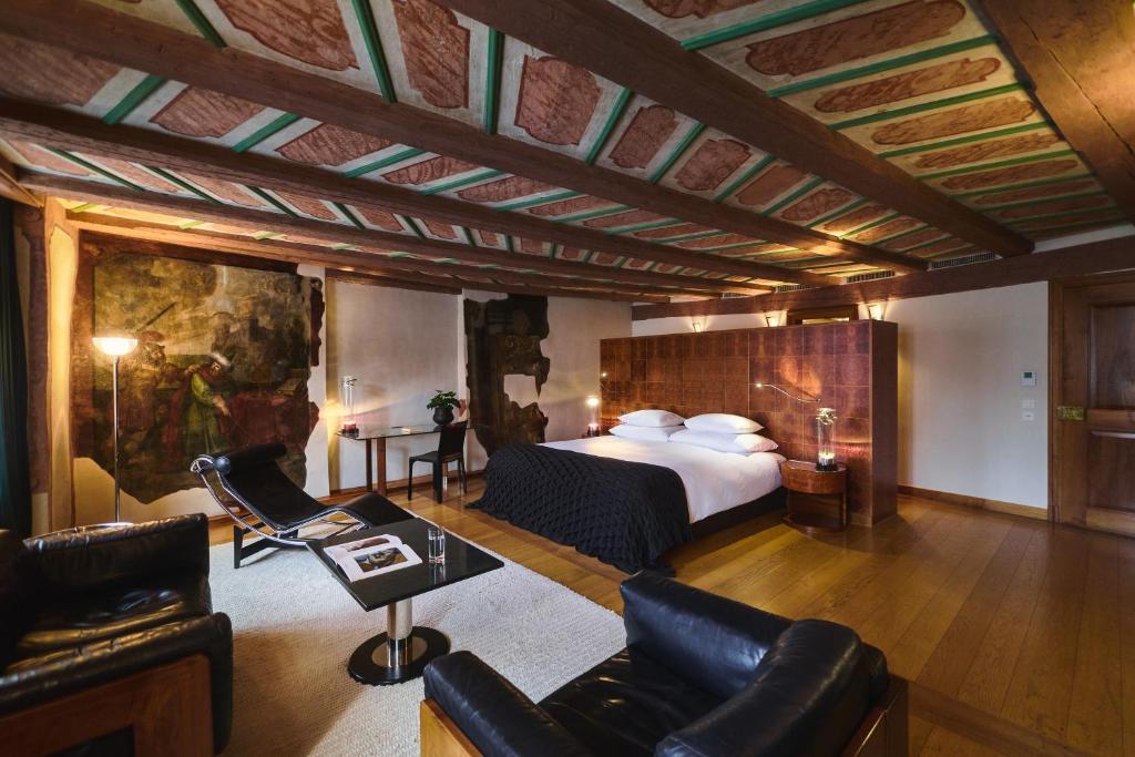 Exposed medieval beams and painted ceiling above modern furniture